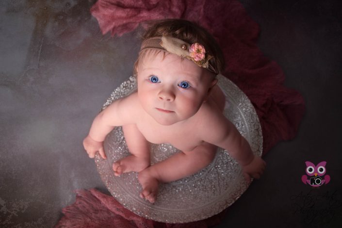 Beautiful Baby girl poses in elegant silver bowl