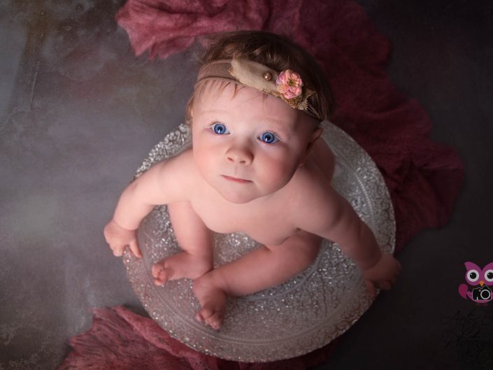 Beautiful Baby girl poses in elegant silver bowl