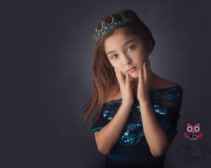 Beautiful little girl poses as a princess