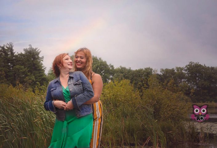 Elegant Women pose near a lake during an engagement session