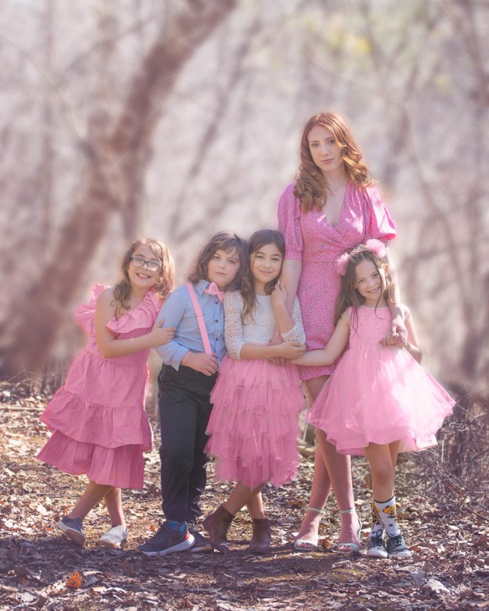 Lovely Cousins pose for family photography session in winter woods