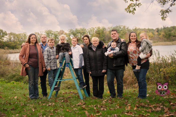 Large Family photo in the woods by a lake