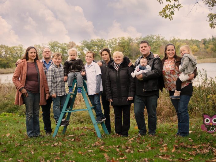 Large Family photo in the woods by a lake