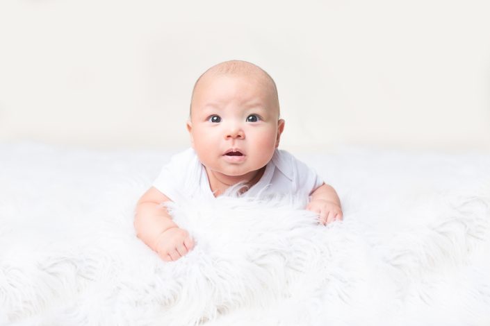 Alert 3 month old poses for milestone photos